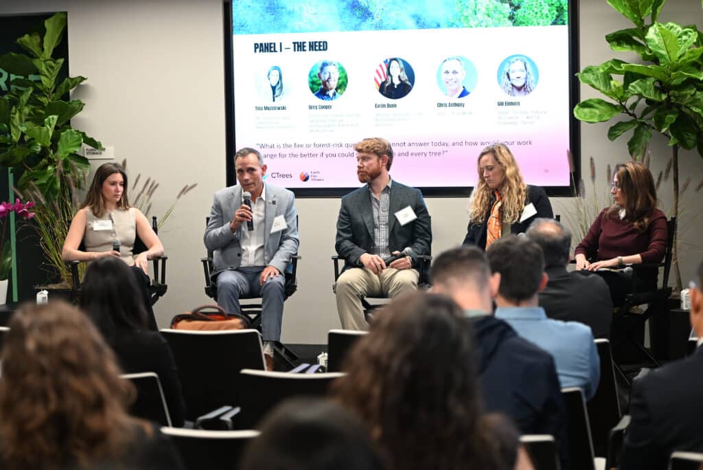 Panelists discuss forest-fire risk before an audience.